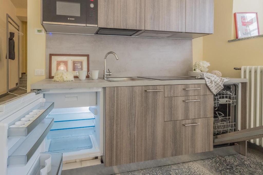 kuchnia ze zlewem i zmywarką do naczyń w obiekcie Tiny Duke Apartment w mieście Varenna