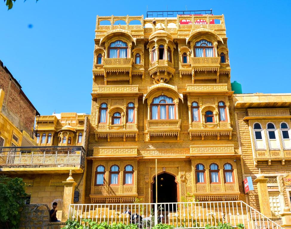 een groot geel gebouw met een hek ervoor bij Hotel Amazing Jaisalmer in Jaisalmer