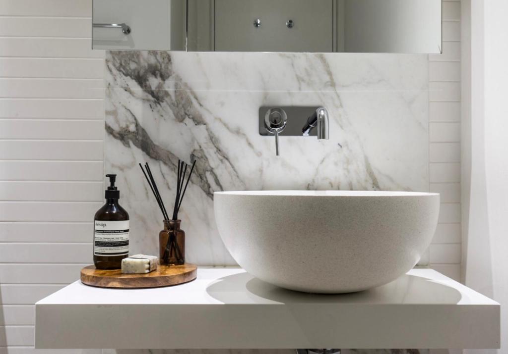 a white bowl on a counter in a bathroom at Boutique Abode 8 in Melbourne