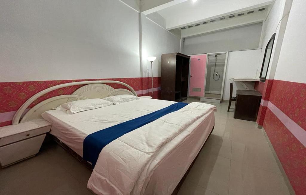 a bedroom with a large bed in a room at Charisma Residence Syariah in Surabaya
