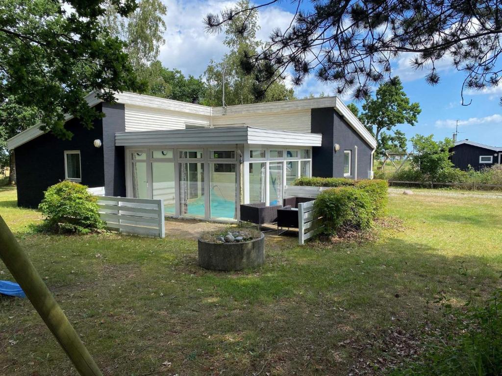 a small house with a pool in the yard at 7 person holiday home in rsted in Kare