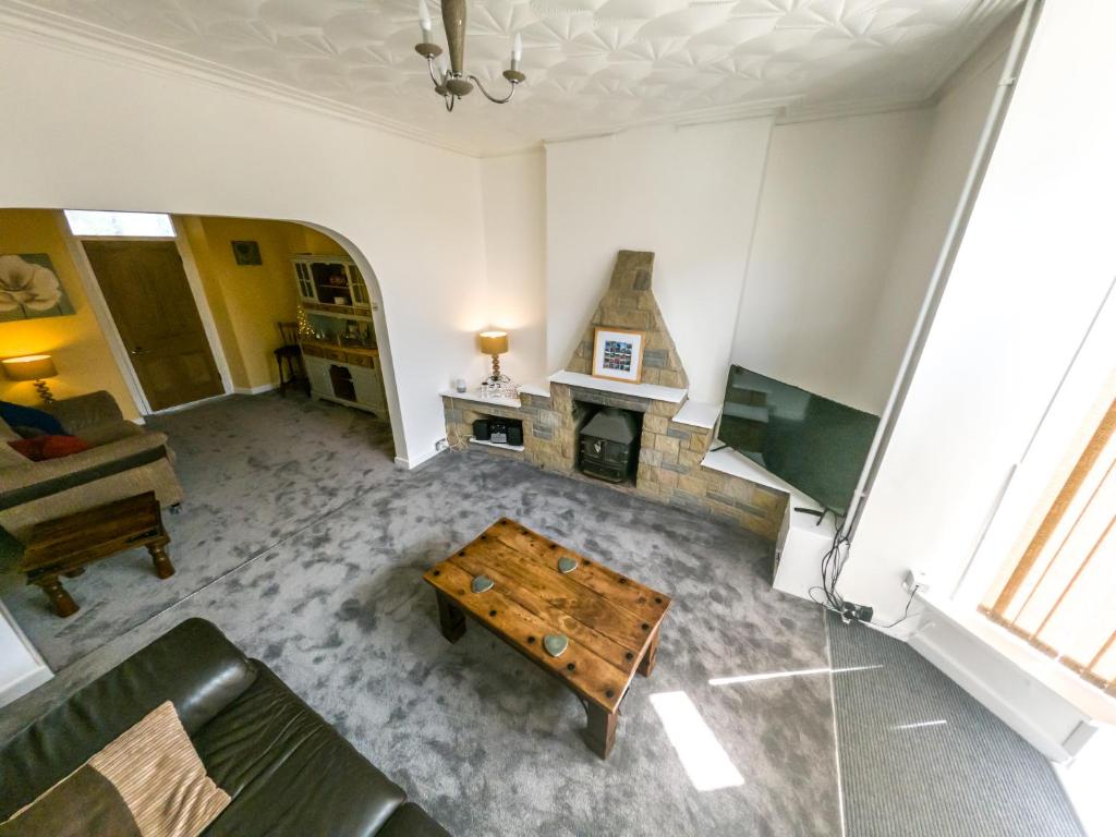 an overhead view of a living room with a fireplace at NEWTON HEATH APARTMENT -750mtrs to beach - Spacious ground floor - Sleeps 6 in Porthcawl