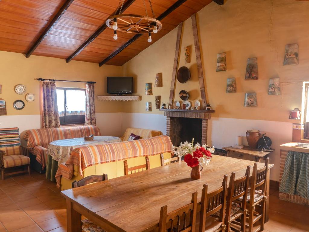 a living room with a wooden table and a couch at Casa Rural Huerta la Lapa in Cañete la Real