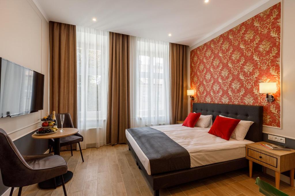 a hotel room with a bed and a table and a chair at AR Apartamenty in Poznań