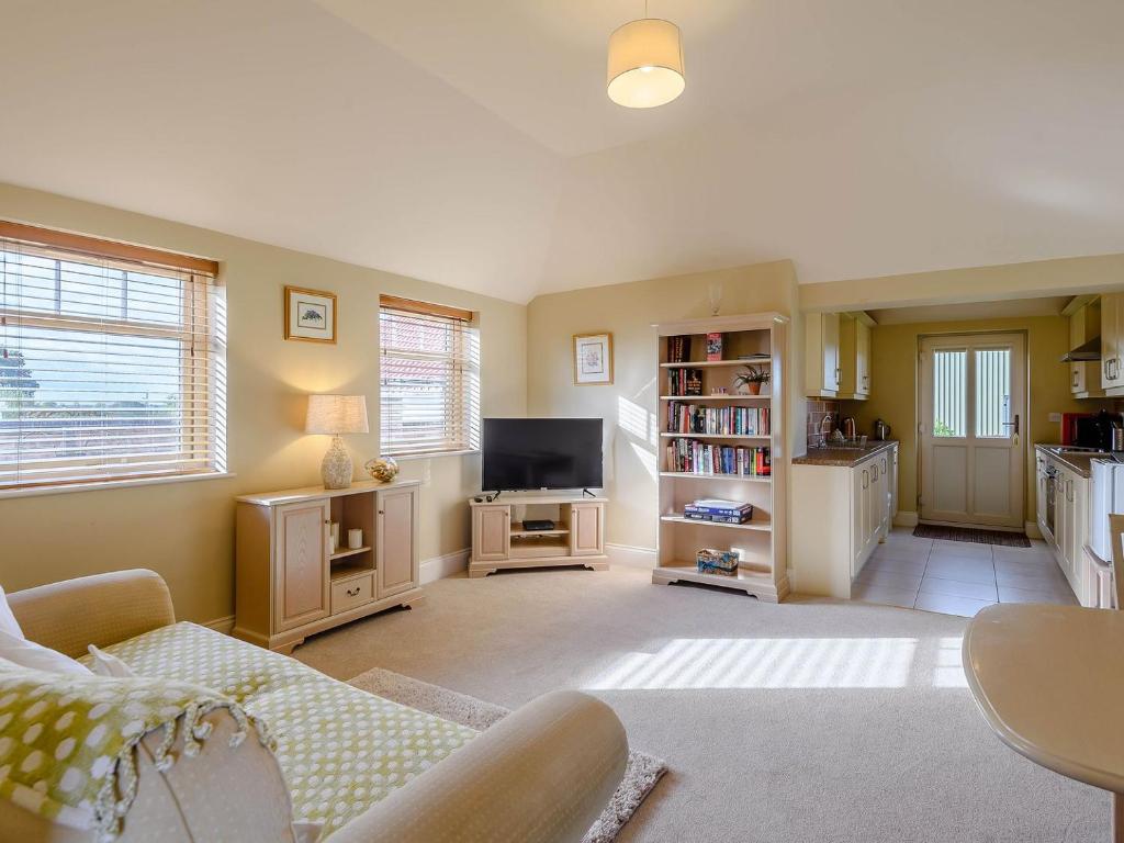 a living room with a couch and a tv at The Parlour - Uk36122 in Horsington