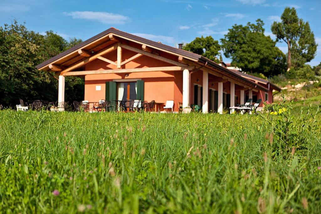 a house with a grassy field in front of it at Agriturismo Il Pianetto in Verona