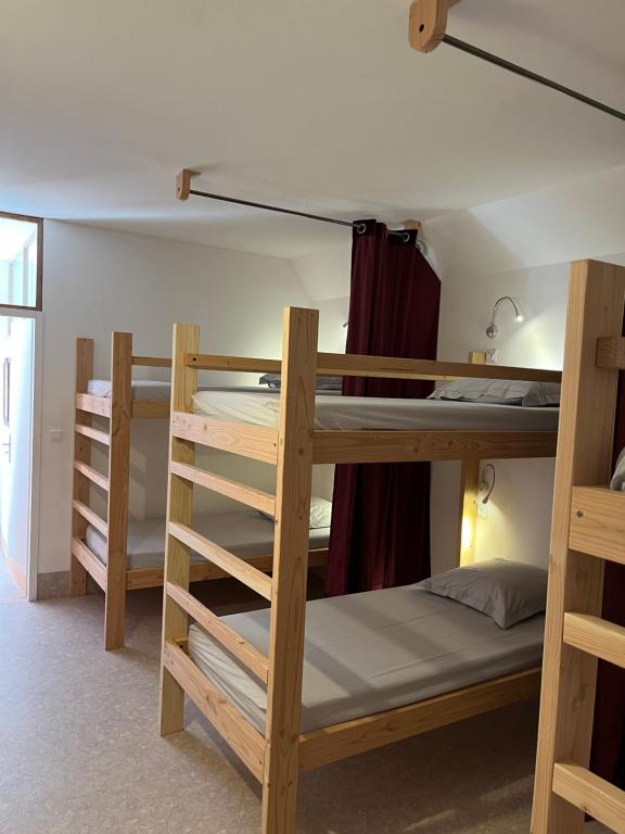 Postel nebo postele na pokoji v ubytování L'Ermitage