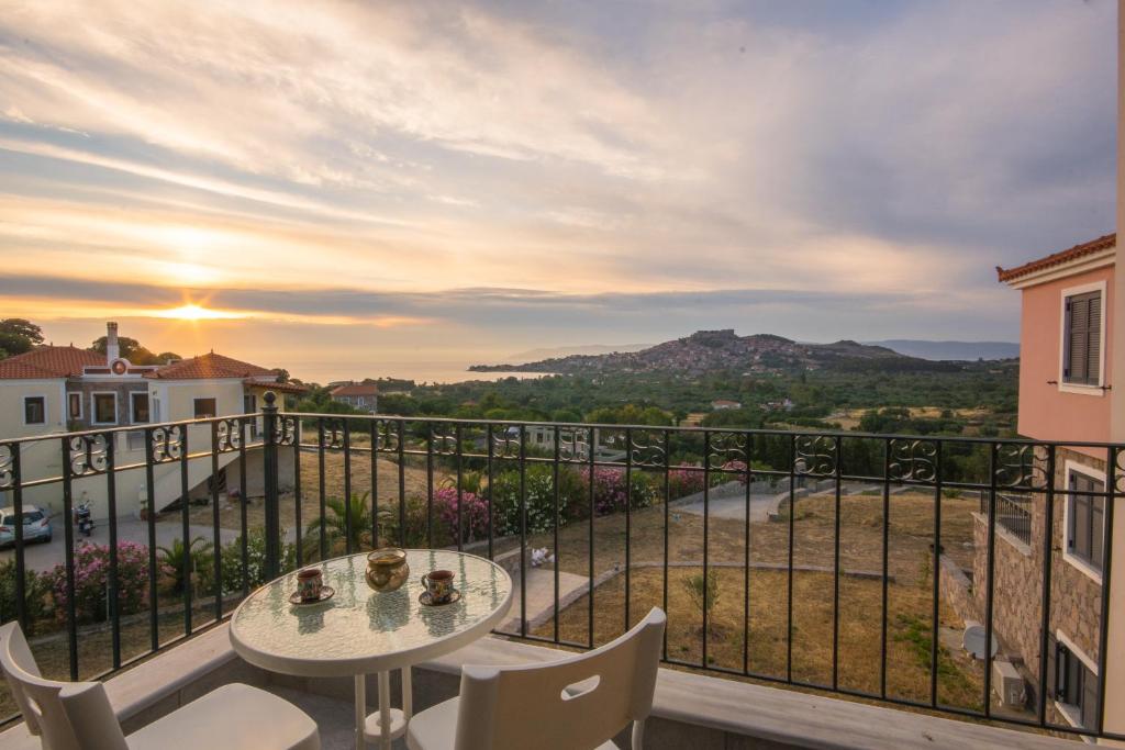 a balcony with a table and chairs and a view at Lampetos Houses Molyvos in Mithymna