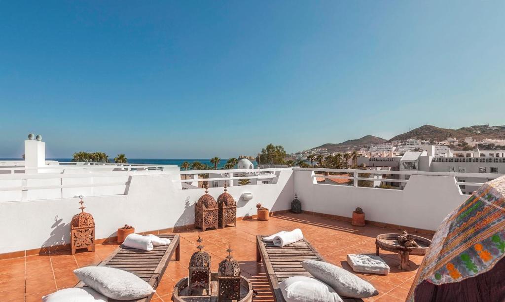 a rooftop patio with pillows and a view of the ocean at Dúplex Playa in San José