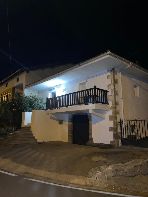 a house with a balcony on the side of it at Vicario etxea in Concha