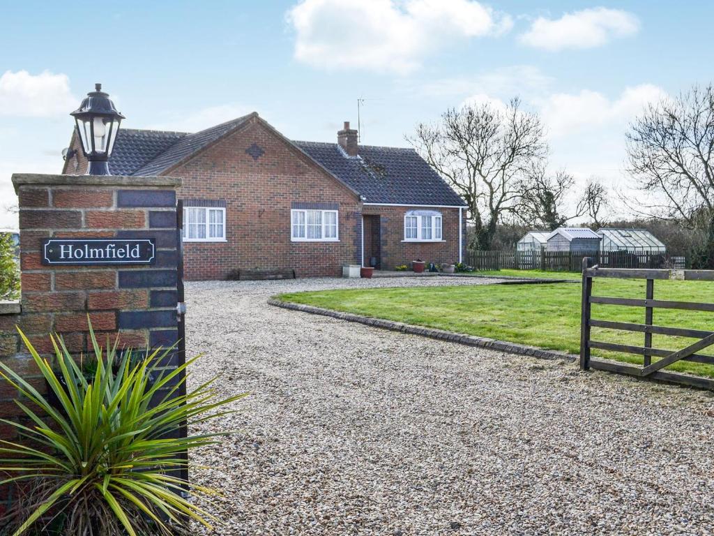 a brick house with a street sign in front of it at Holmfield in Willoughby