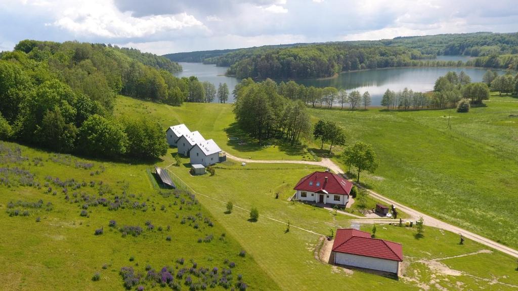 an aerial view of a farm with a house and a barn at Sikory Hill in Czaplinek