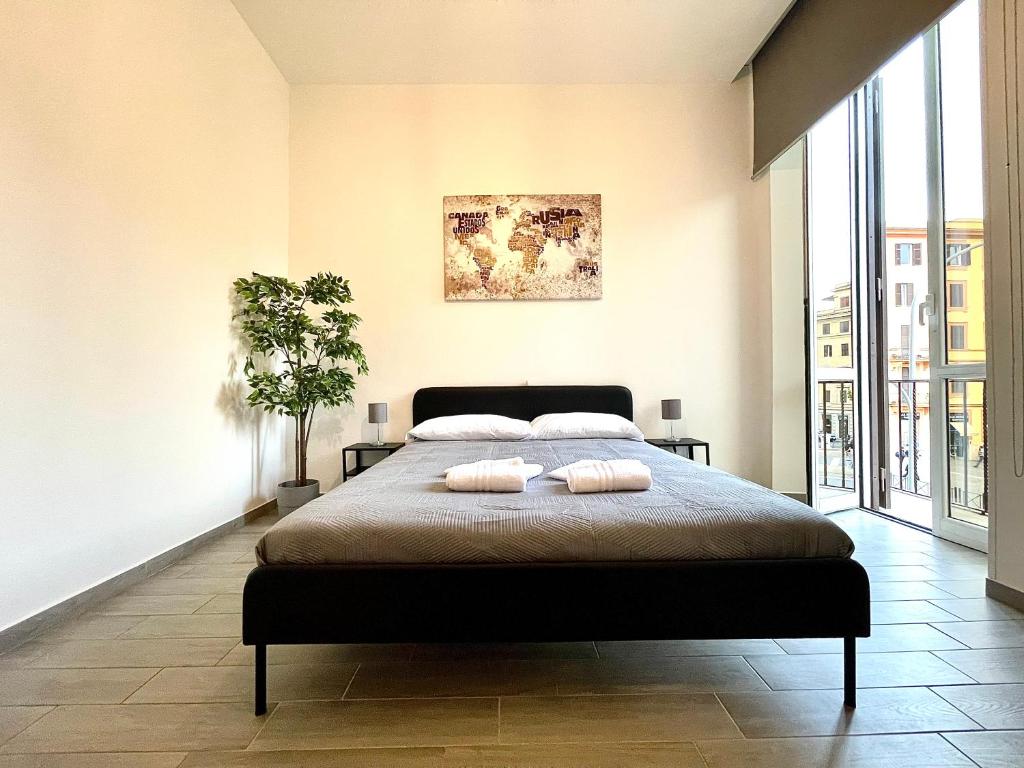 a bedroom with a large bed with two pillows on it at Colosseum Guest House in Rome