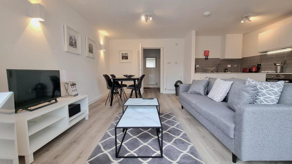 a living room with a couch and a table at Roomspace Serviced Apartments - Kew Bridge Court in London
