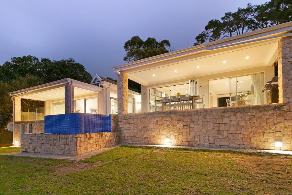 a home with a stone wall at Lyons Den - No Load Shedding in Cape Town