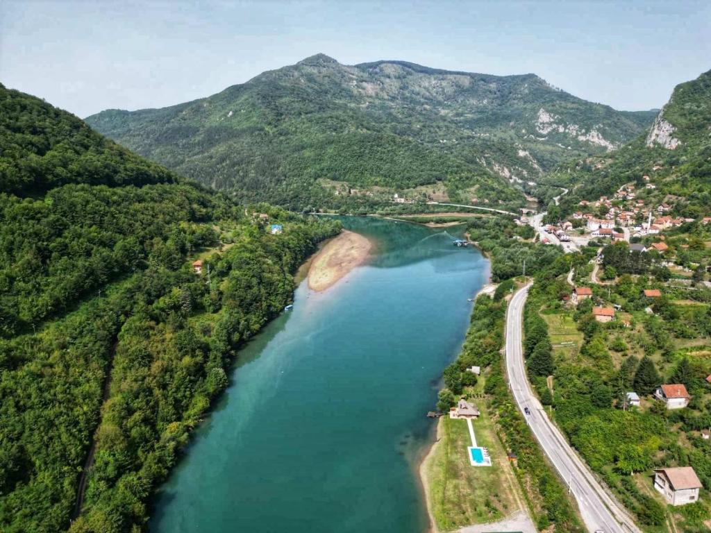 an aerial view of a river with mountains at Villa California in Rezine