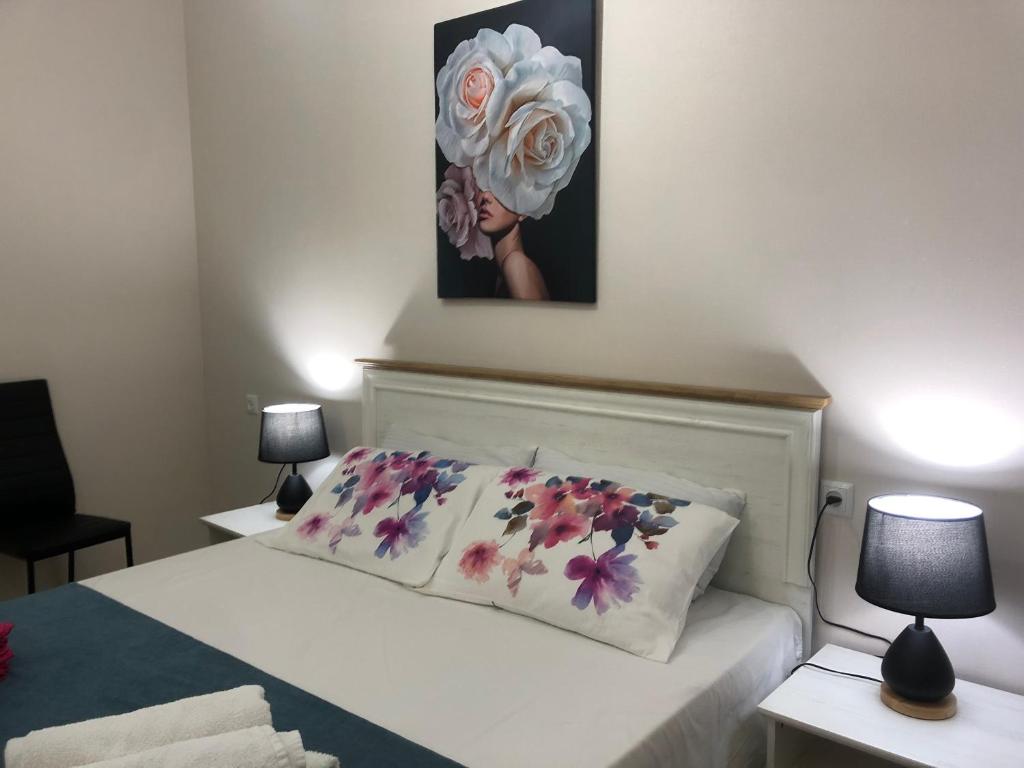 a bedroom with a bed with a flower pillow on it at central square in Kutaisi
