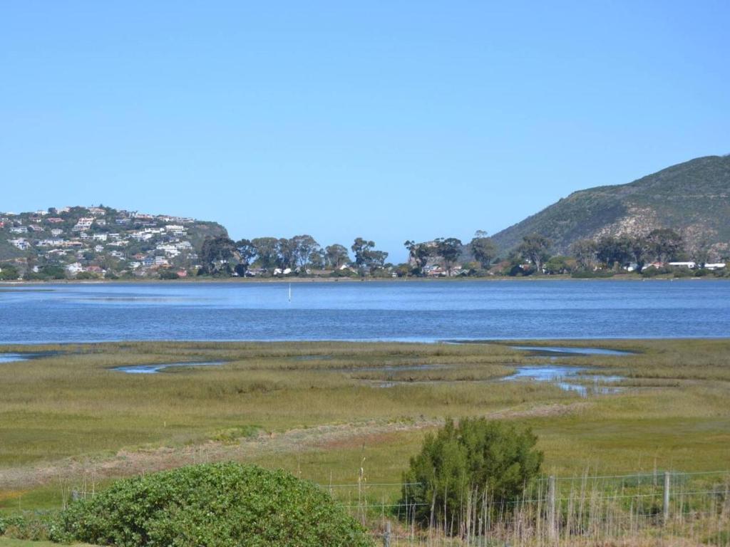 a large body of water with mountains in the background at Thesen View - exquisite views with bikes & canoe in Knysna