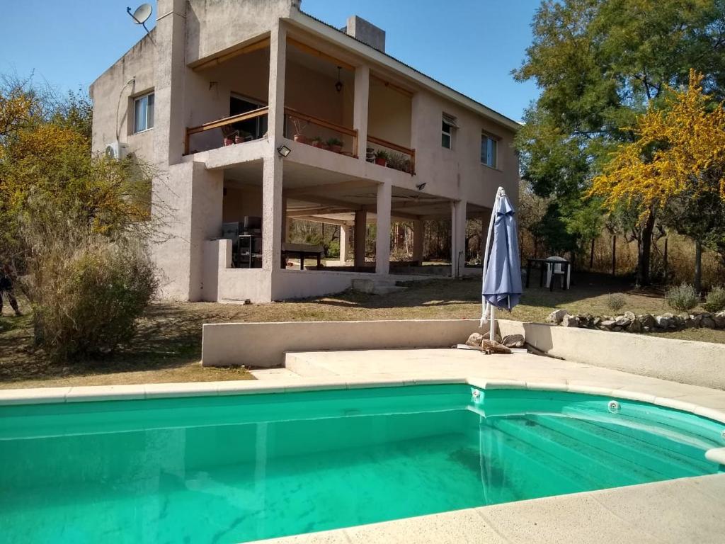 a house with a swimming pool in front of a house at Casa en Villa Los Aromos in La Bolsa