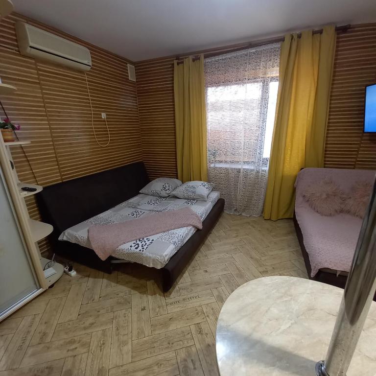 Postel nebo postele na pokoji v ubytování Апартаменты-студио