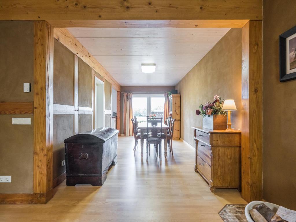 a living room with a wooden floor and a table at Waldsiedlung No2 in Kröpelin