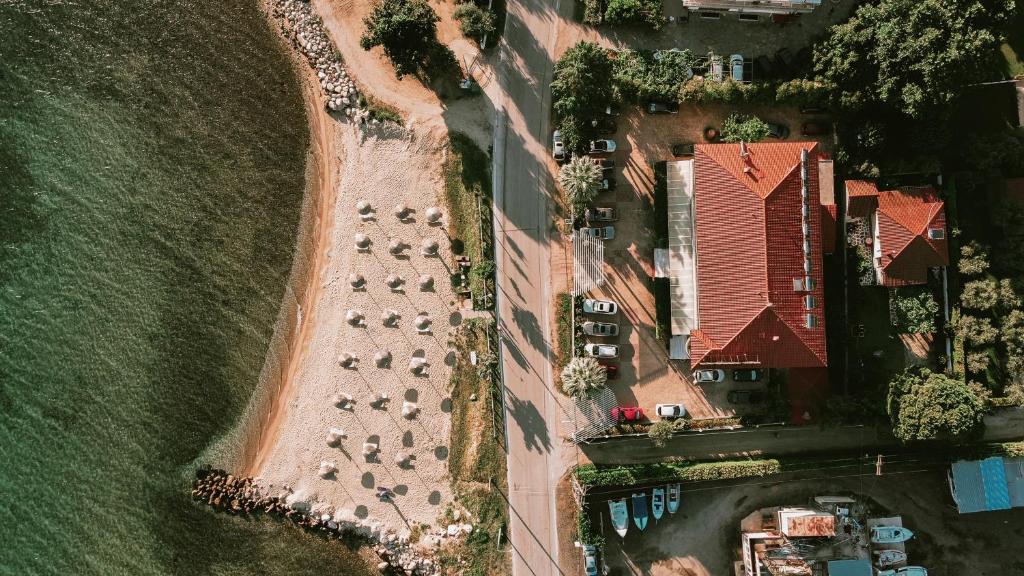 an overhead view of a parking lot with parked cars at Calma Beach Hotel in Stavros