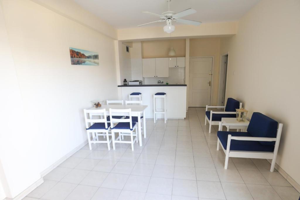 a living room with a table and chairs and a kitchen at Larnaca Center Apartments in Larnaka
