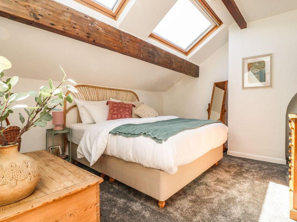 a bedroom with a bed and a skylight at Number 61 Skipton in Skipton