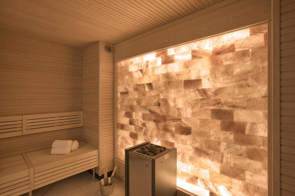 a stone wall in a sauna with a trash can at Apogée Courchevel, Oetker Hotels in Courchevel