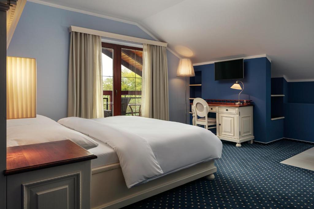 Postel nebo postele na pokoji v ubytování Golf & Spa Kunětická Hora