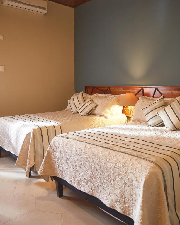 Voodi või voodid majutusasutuse Hotel Plaza Copan toas