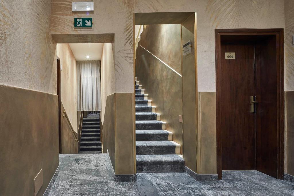 a hallway with stairs in a building with a sign at Hotel Orsaria in Venice