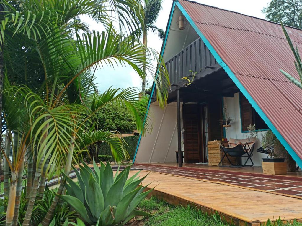 a house with a red roof and a wooden deck at Casa de campo, charme e aconchego em cond. fechado in Atibaia