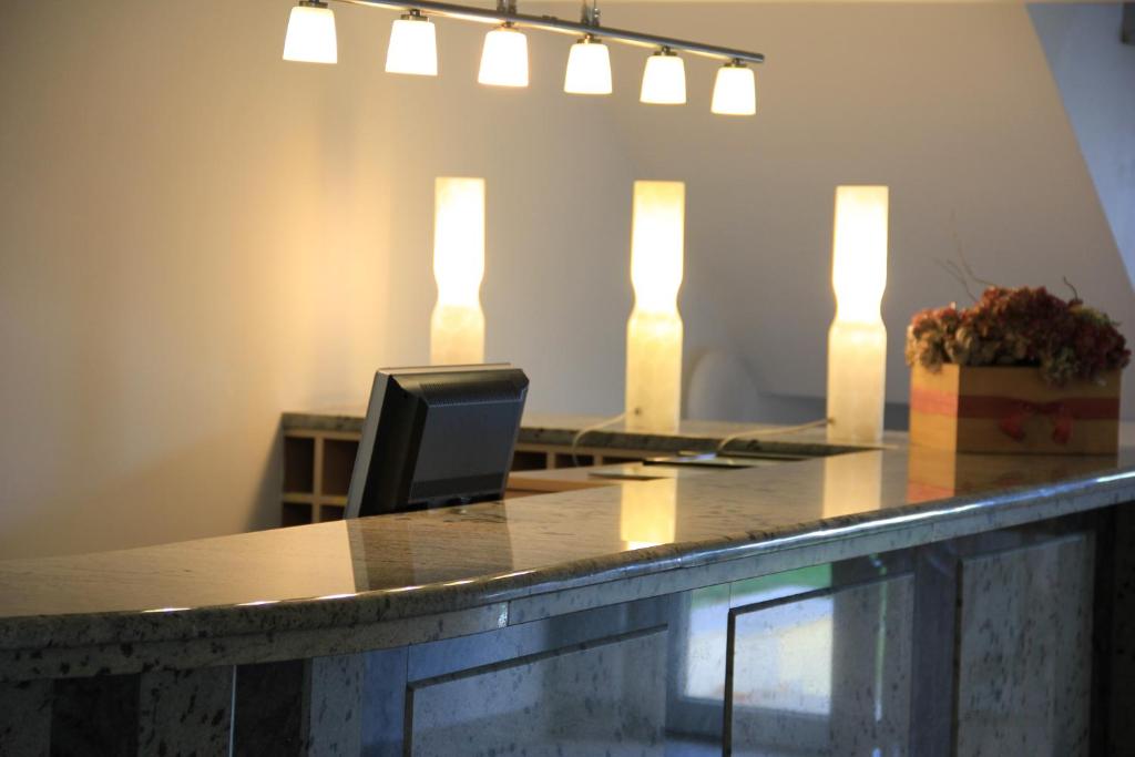 a bar with a desk with a computer on it at La Ermita in Brunete