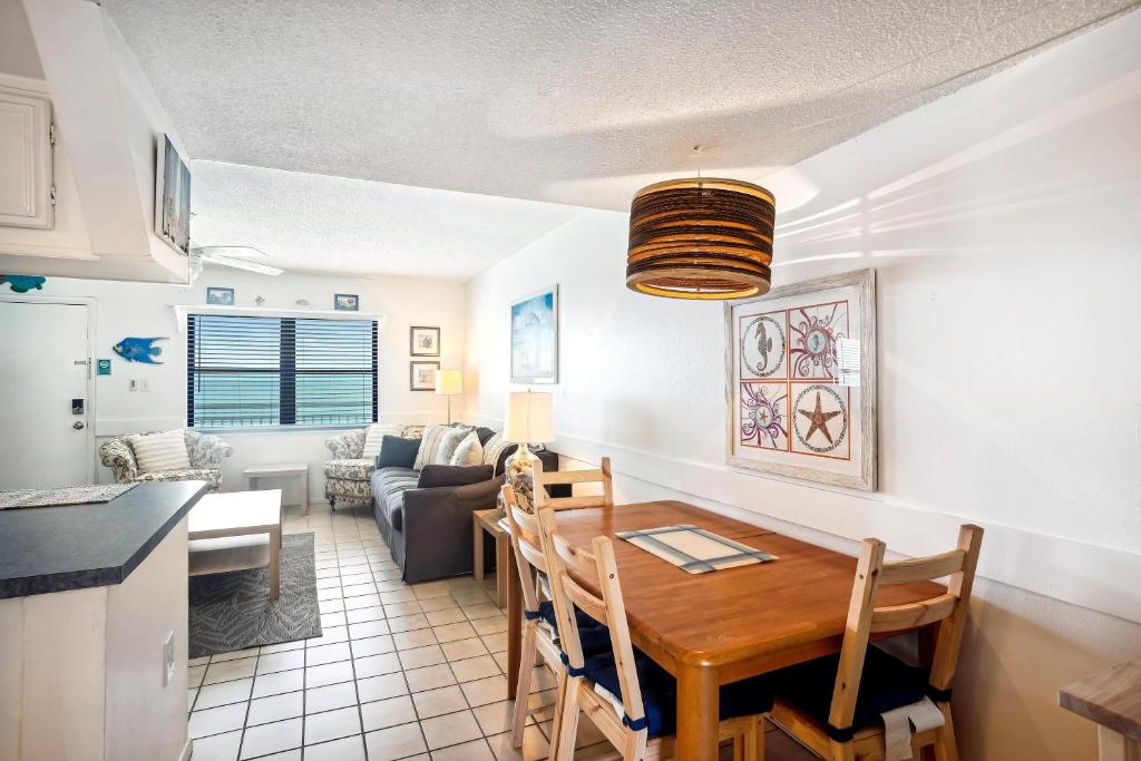 a kitchen and living room with a dining room table at Sunset Chateau 409 in St Pete Beach