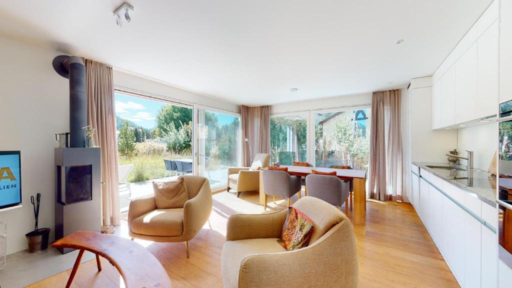 a living room with chairs and a dining room at Abitaziun Bellaval 1A - Celerina in Celerina