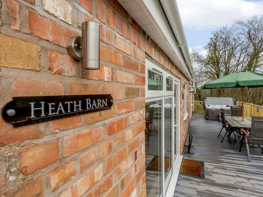 a brick building with a health bar sign on it at Heath Barn in Suckley