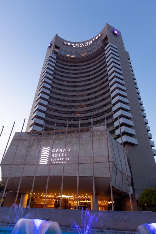 a tall building with a sign on the side of it at Grand Hotel Bucharest in Bucharest