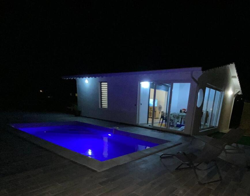 a swimming pool in front of a house at night at Villa Catalina in Le Moule