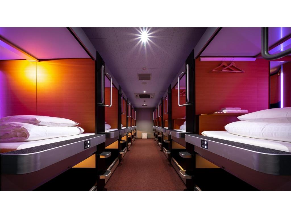 a row of beds in a train car at The Lodge Moiwa 834 - Vacation STAY 36156v in Niseko