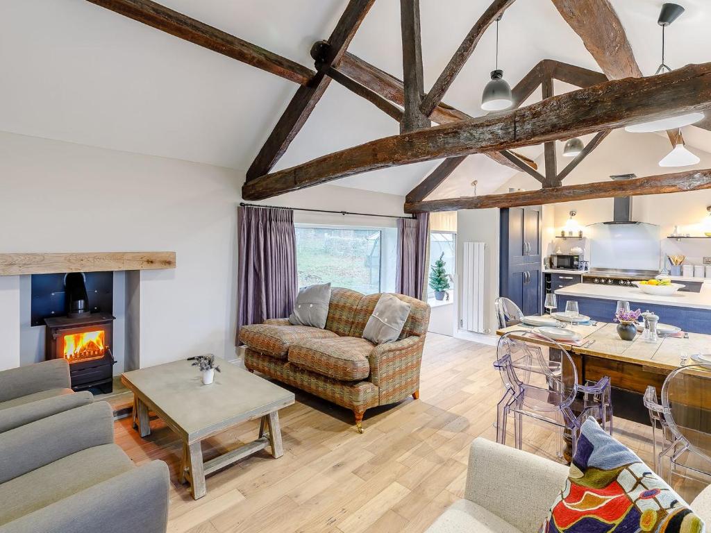 a living room with a couch and a fireplace at Old Tannery in Farnley Tyas