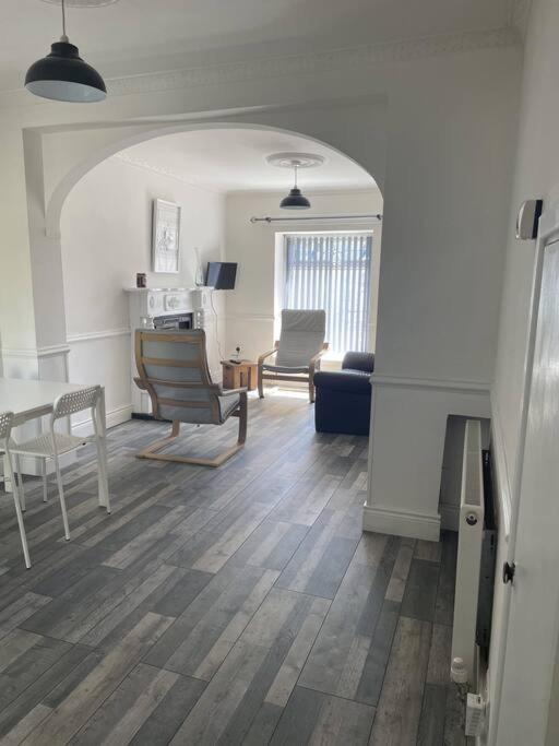 a living room with a couch and a table and chairs at Acushla House in Londonderry County Borough