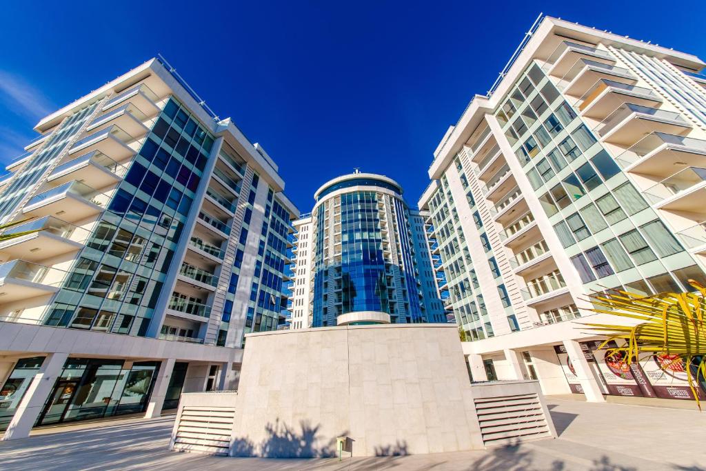 a group of tall buildings against a blue sky at Hotel Tre Canne in Budva