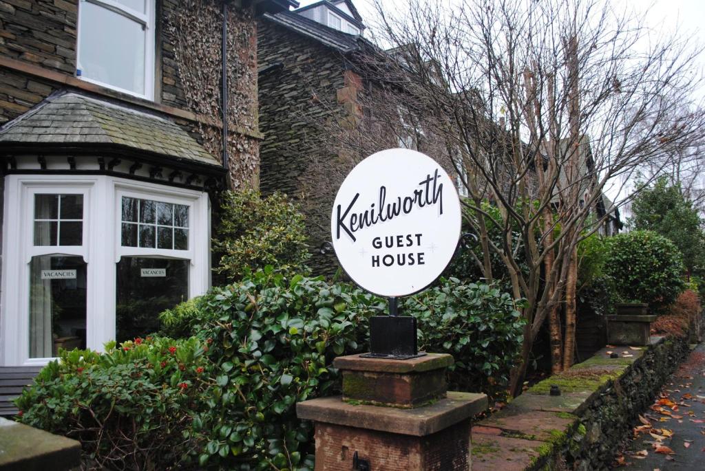 a guest house sign in front of a house at Kenilworth Guest House in Windermere