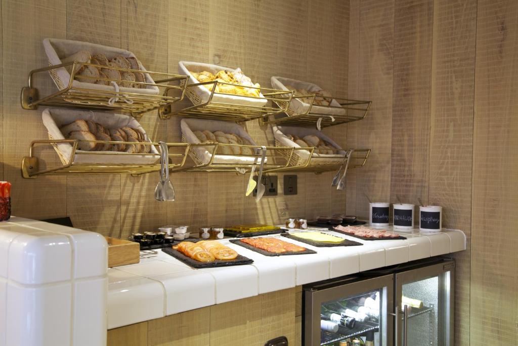 a kitchen with a counter with food and bread at The Z Hotel Soho in London