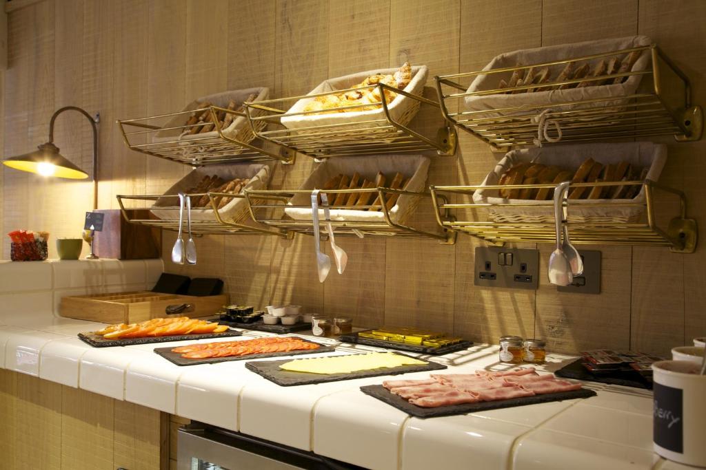 a kitchen with a counter with some food on it at The Z Hotel Soho in London