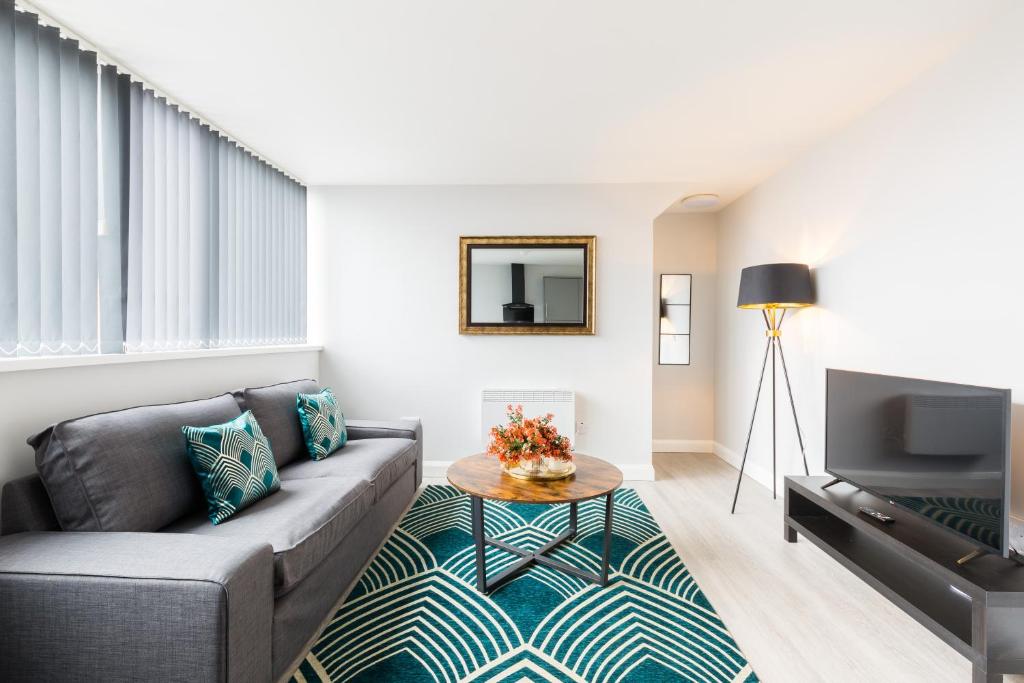 a living room with a couch and a tv at Hagley Road Apartments - Self Contained Entire Apartments with Kitchen & Netflix - Birmingham City Centre in Birmingham