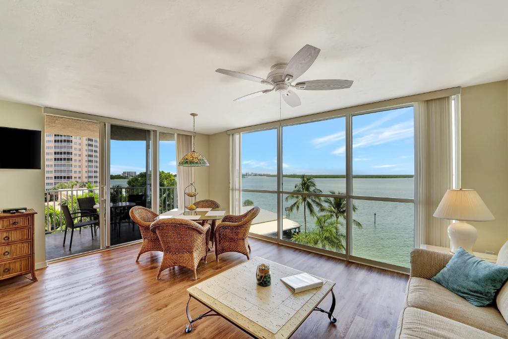 a living room with a table and a view of the ocean at Tropical Paradise in Fort Myers Beach
