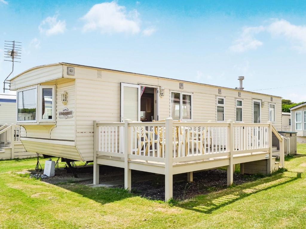 a mobile home with a porch and a deck at Becleigh-daisy in Bacton