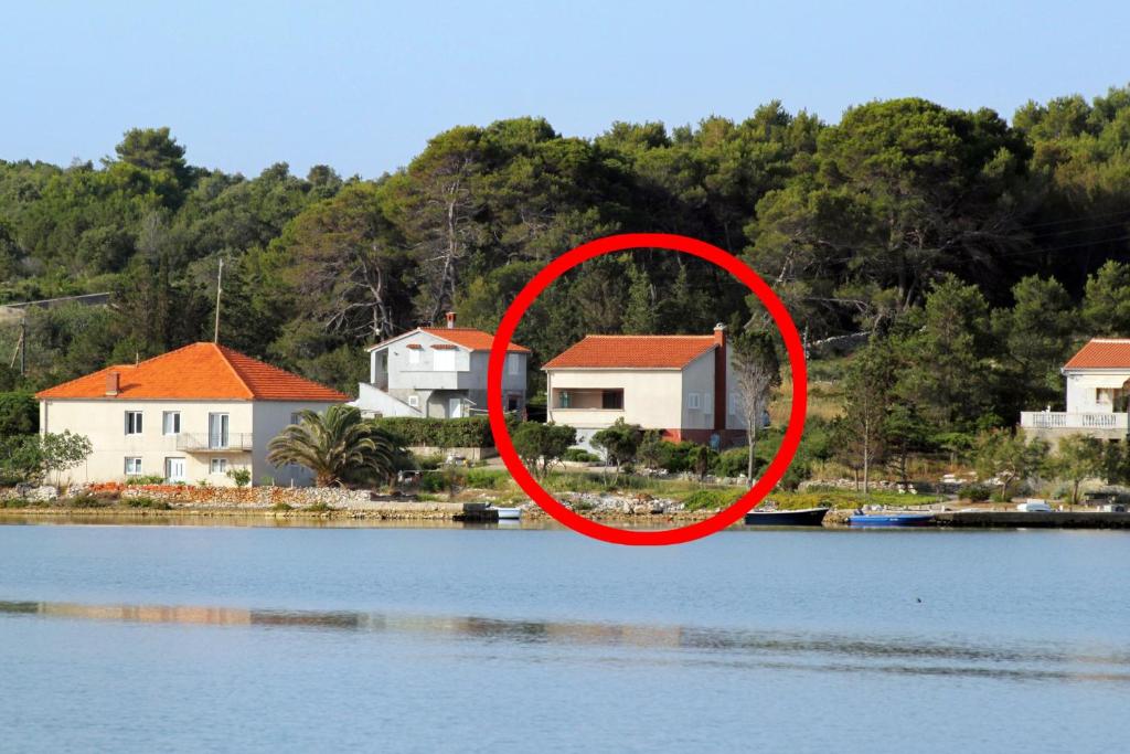 a red circle around a house next to a body of water at Seaside holiday house Veli Rat, Dugi otok - 875 in Veli Rat